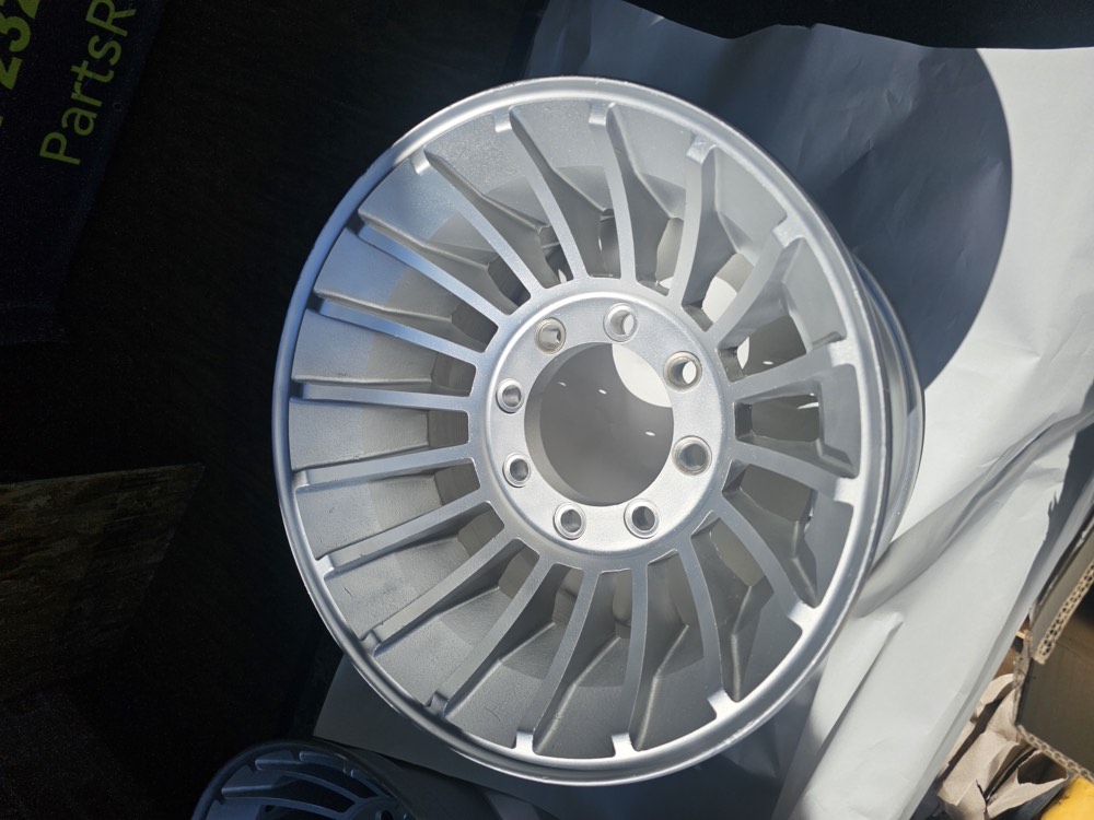 Truck wheel after restoration, stripped to an even satin aluminum finish